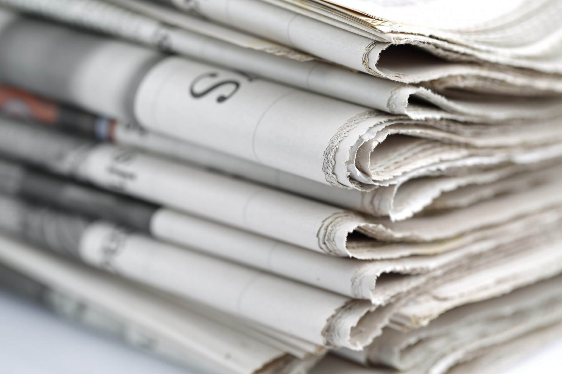 Newspapers folded and stacked concept